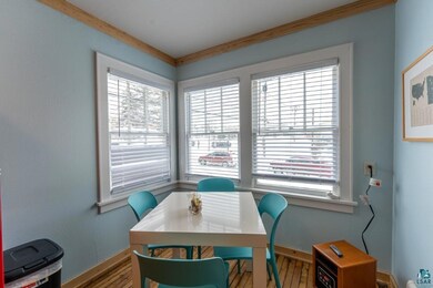 Dining space with hardwood / wood-style flooring