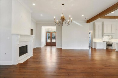 great room, wood floor, fireplace, crown molding,