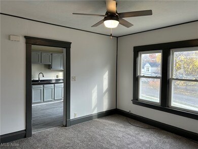 Carpeted empty room with ceiling fan