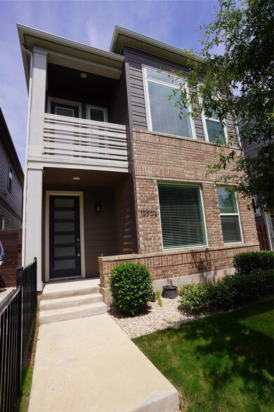 View of front of house with a balcony and brick s
