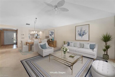 Carpeted living room with lofted ceiling and ceili
