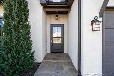 The entryway sidewalk features Travertine tile