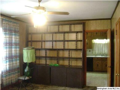 Solid wood paneled den with built-in book shelves.