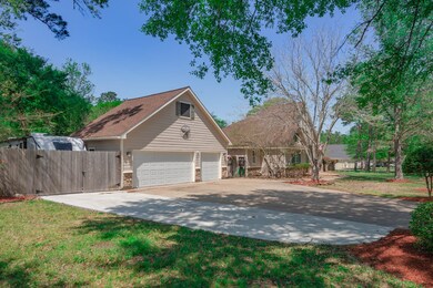 3 car garage with additional storage above and Extra-wide driveway with additional RV parking and 30 amp RV hook-up.