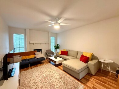 Living area with wood finished floors, ceiling fa