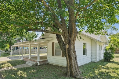 View of side of home with roof with shingles