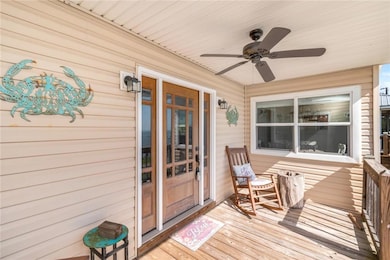Wooden deck featuring ceiling fan
