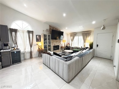 Living room featuring a fireplace, lofted ceiling,