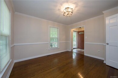Formal dining room with crown molding and chair ra