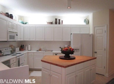Large kitchen with butcher blocktop center island.
