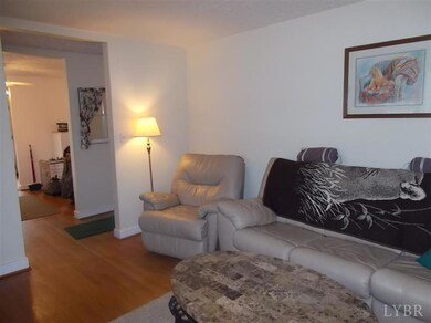 Another view from within the living room towards the entry foyer and dining room.