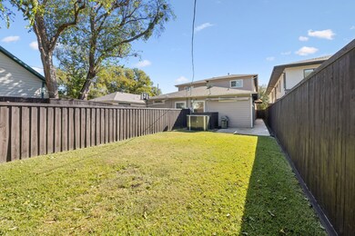 Rear view of house with a fenced backyard and a patio area