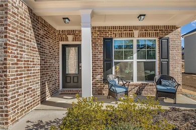 Doorway to property featuring covered porch