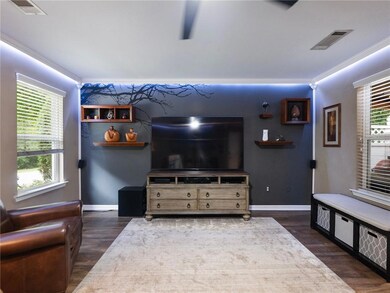 Living area featuring ornamental molding, wood finished floors, and baseboards