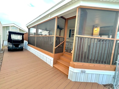 Deck featuring a sunroom and a ceiling fan