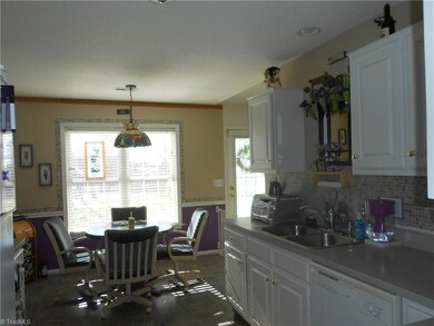 Enjoy meals in this eat in kitchen overlooking the back yard.
