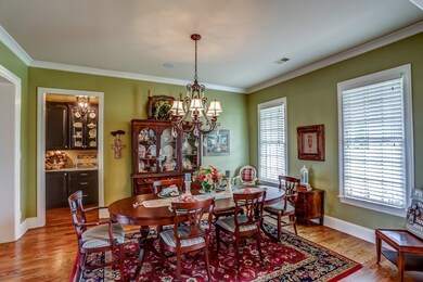 Elegant formal dining room has adjoining butlery w