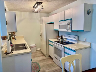 Kitchen featuring a sink, light countertops, white