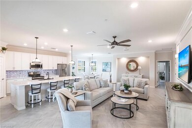 Living room featuring crown molding, sink, light t