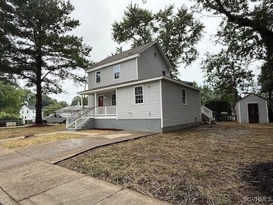 Traditional home with a porch and a storage unit