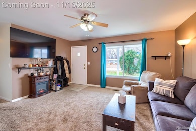 Living area with carpet flooring and ceiling fan