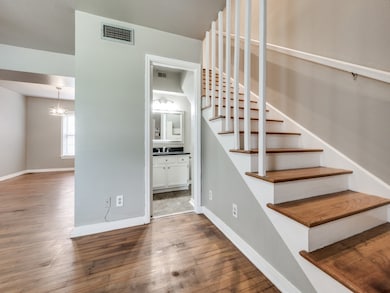 Staircase featuring hardwood / wood-style floors and baseboards