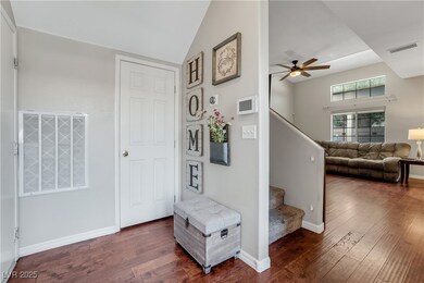 Hallway with stairs, dark wood-type flooring, and