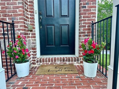 Doorway to property featuring brick siding