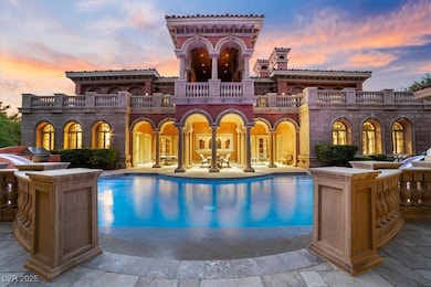 Back of house featuring a balcony, an outdoor pool