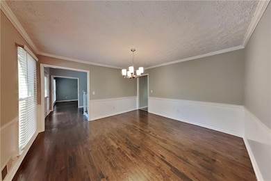 Stairway featuring crown molding, wood finished fl