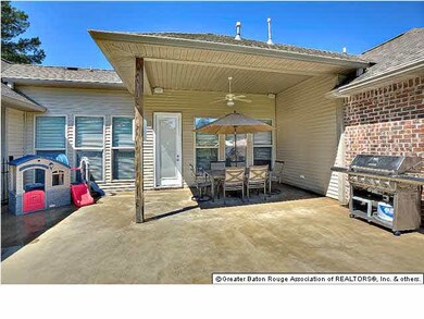 Covered and extended patio has stained concrete.