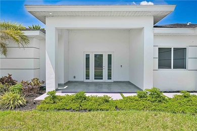 Doorway to property with french doors and stucco s