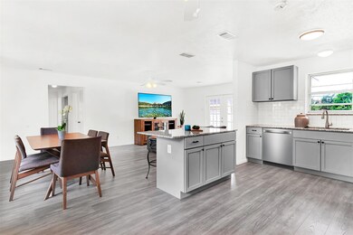 Breakfast area, dining and living rooms are open to the kitchen.