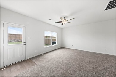 Empty room with light carpet and ceiling fan