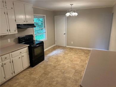 view of kitchen and eating area from garage entran