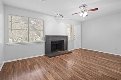 Unfurnished living room featuring wood finished f