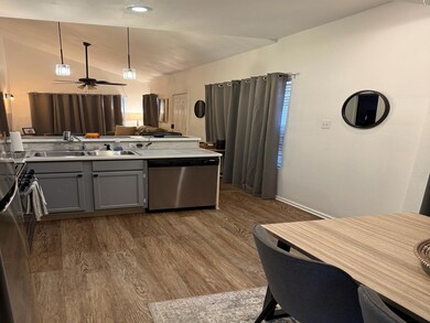 Kitchen featuring gray cabinetry, sink, dark hardw