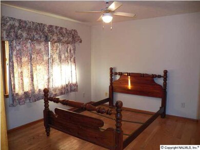 Master bedroom with hardwood floors.
