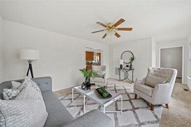 Living room featuring light carpet and ceiling fan