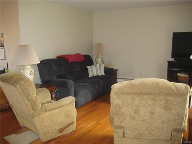 Open floorplan with gleaming hardwood floors.