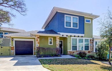 View of front facade with a front yard, driveway,