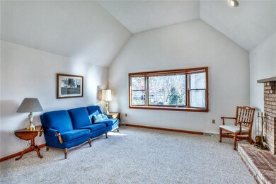 Living room with fireplace and vaulted ceilings.