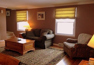 Living room with crown molding and updated windows