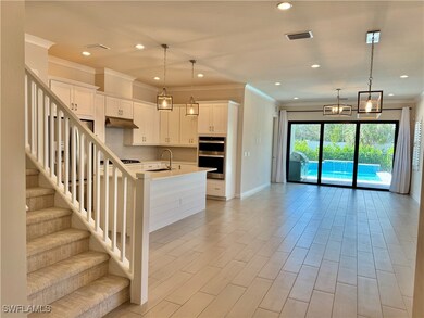 Kitchen featuring a center island with sink, sink,