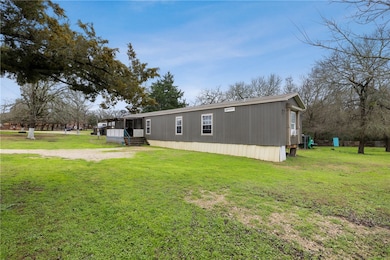 Back of house with a lawn