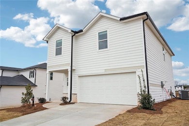 View of front of home featuring a garage and centr