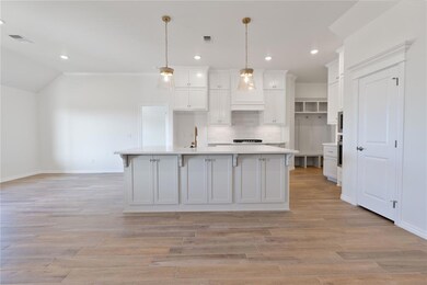 Kitchen with white cabinets, decorative light fixt