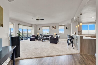 Living room featuring a ceiling fan and light wood