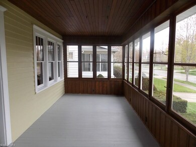 Front porch with painted wood floors and pine wall