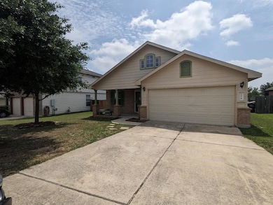 View of front facade featuring driveway, brick si